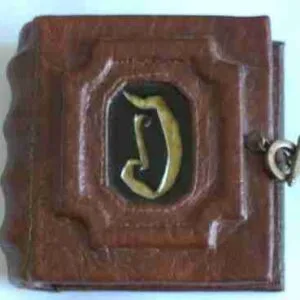 Address Book Handcrafted mini address book with a gold-painted initial on the cover, featuring hand-sewn binding and a personalized touch. Available in larger sizes.