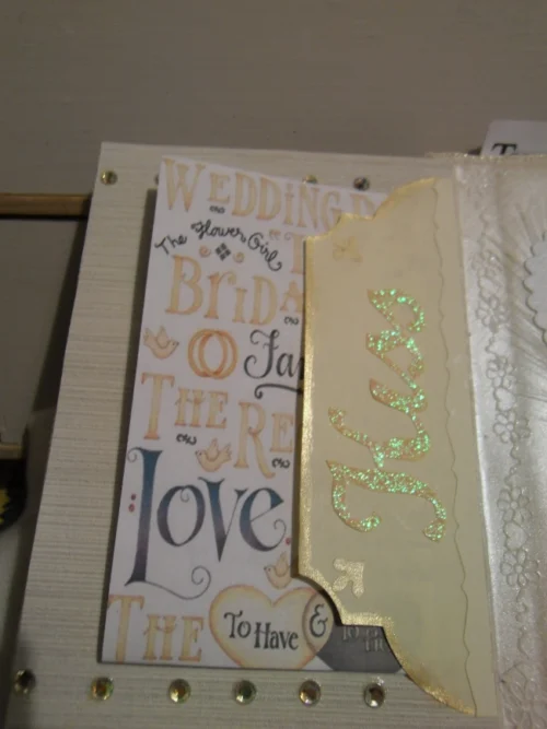 Wedding-1 A cream-coloured fabric wedding album with Latin phrases, featuring photo mats, pockets for keepsakes, and blog spots for personal notes, designed to preserve cherished memories in a timeless and functional way.