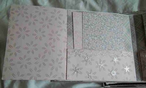 Wedding-4 is a photo album designed to hold up to 40 wedding photos. It features elegant photo mats, pockets for extra mementos, and spaces for personal notes to describe the memories and emotions behind each image.