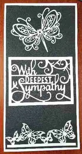 Sympathy Card-3 A tall sympathy card with a black textured background, featuring a row of white lace butterflies along the bottom and a larger lace butterfly at the top. The words "With Deepest Sympathy" are cut out in the centre.