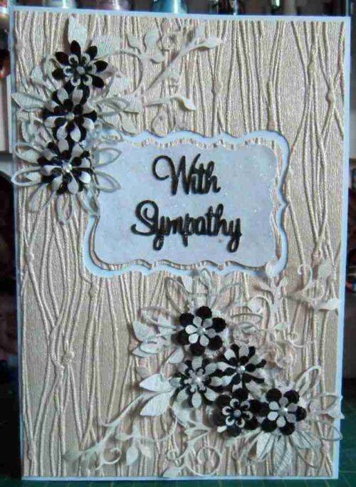 sympathy1 card, with sympathy in the centre, cream background, black and white flowers