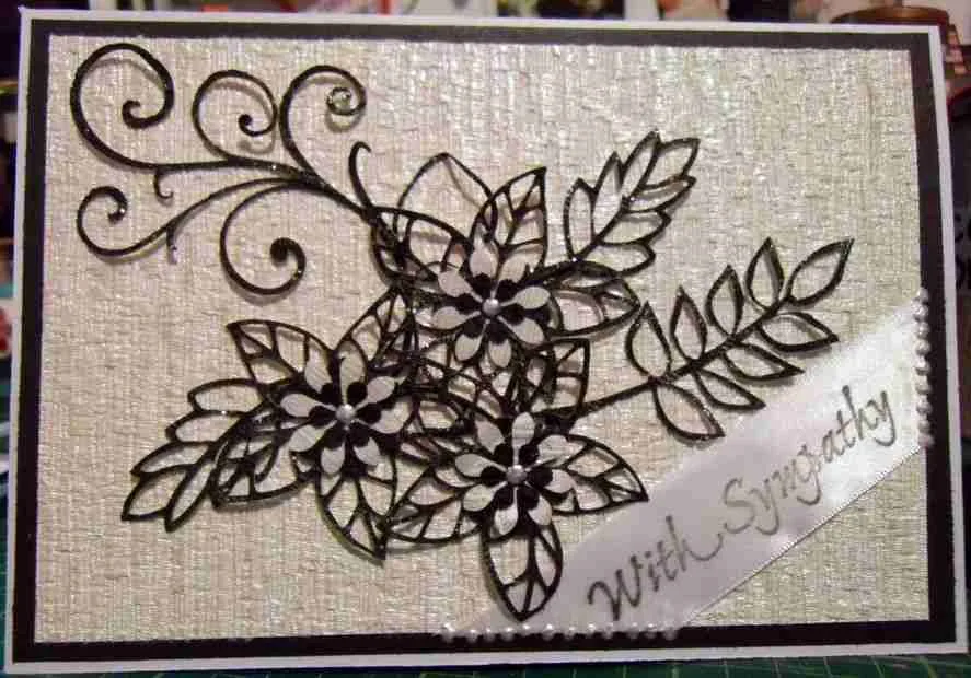 Sympathy Card-2, a sympathy card with black skeleton-like flowers and leaves on a cream textured background, featuring a "With Sympathy" ribbon tag in the bottom right corner.
