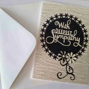 Sympathy Card-5 Handmade sympathy card with beige textured paper, featuring a black circle with the words "With Deepest Sympathy" and two black and beige floral accents at the bottom right.