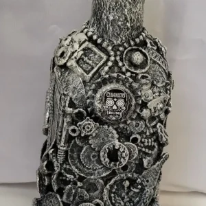 Bottle-O-Rum-1 Bottle with a textured surface of recycled metals, plastics, and broken chains.