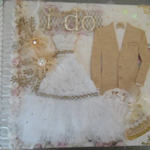 Wedding-3 a tactile photo album featuring a textured lace and tulle bridal gown, a gold groom's jacket, and "I DO" in gold.