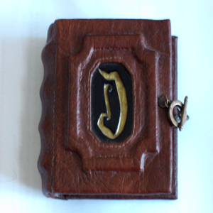 Galleries image of an Address Bk-1 front cover of a brown faux leather book, the Letter D in the center