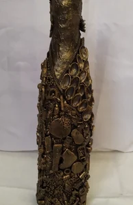 Bronze Bottle-1, covered in recycled mixed media, all with a golden bronze finish.