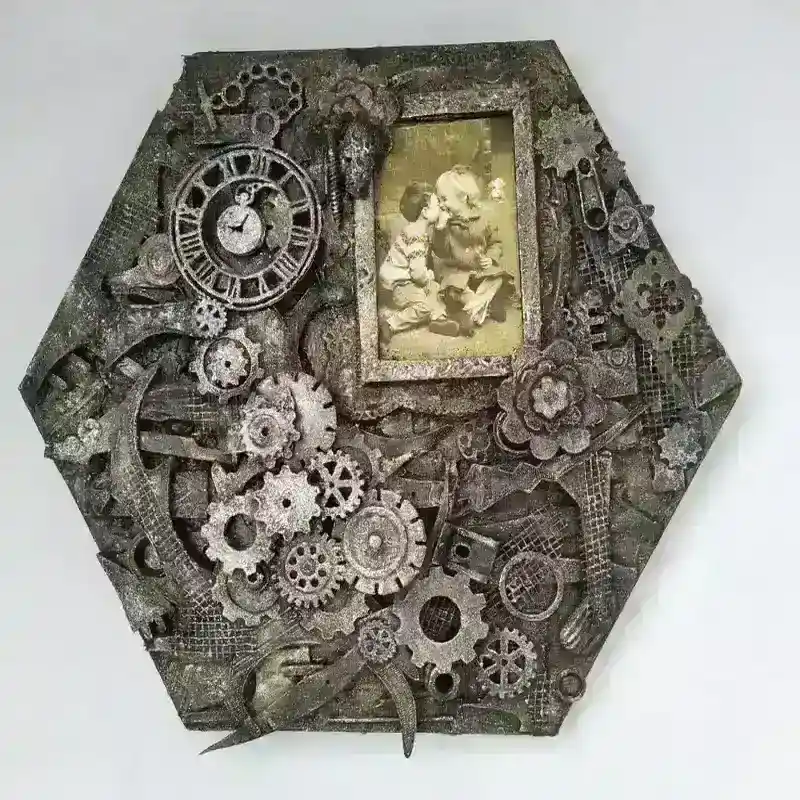 Mixed‑media hexagonal artwork titled A Moment in Time, featuring layered gears, cogs, and clock parts surrounding a small vintage photograph set into the composition.