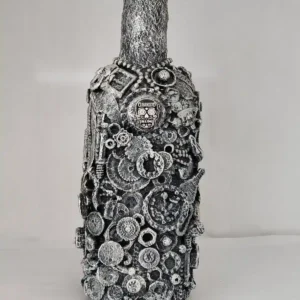 Bottle-O-Rum, a mixed media bottle covered with detritus of glass shards, small plastics and mixed metal pieces