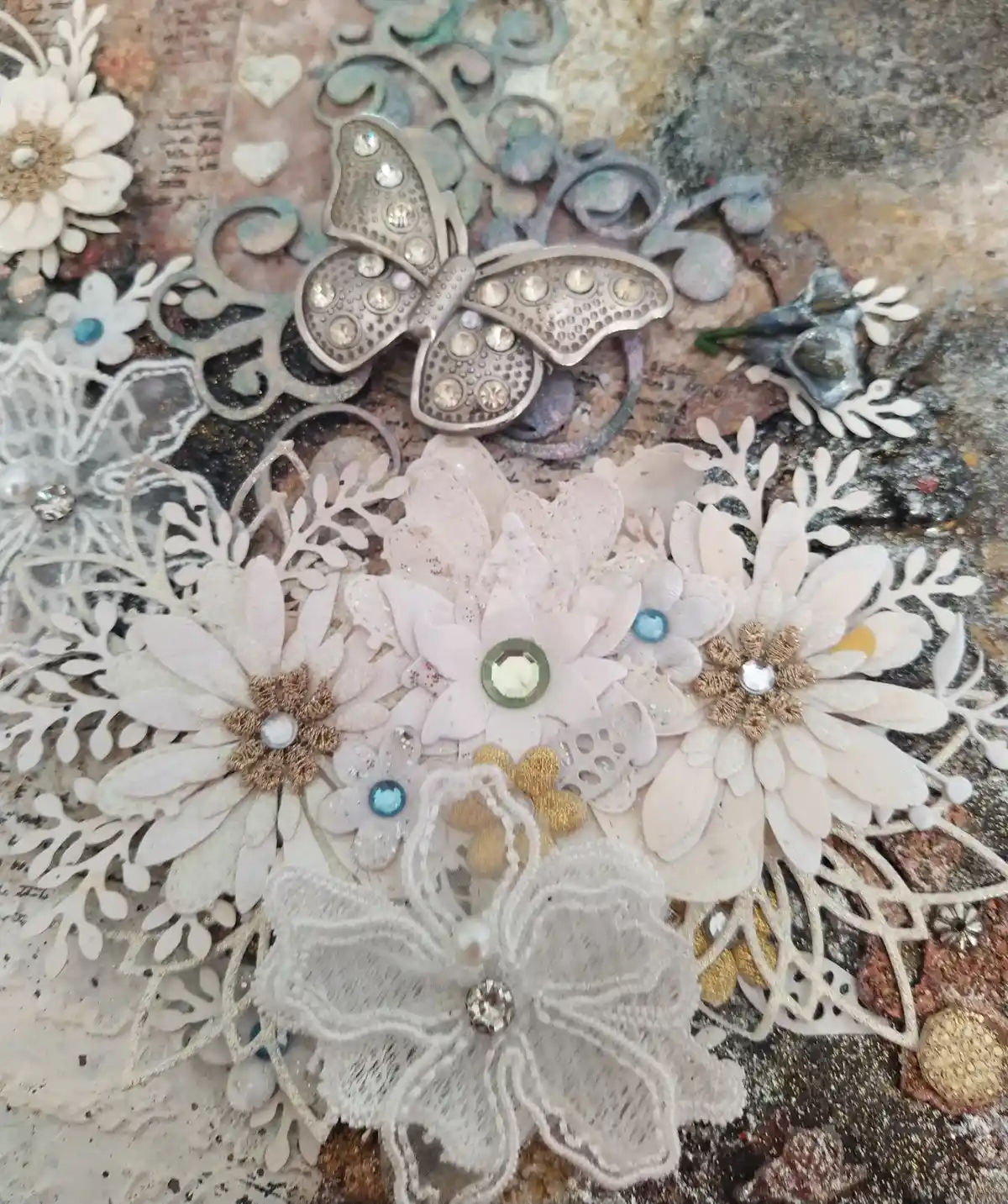 The Gentle Flutter, close up of mixed‑media artwork featuring a metallic butterfly, lace textures, and soft florals