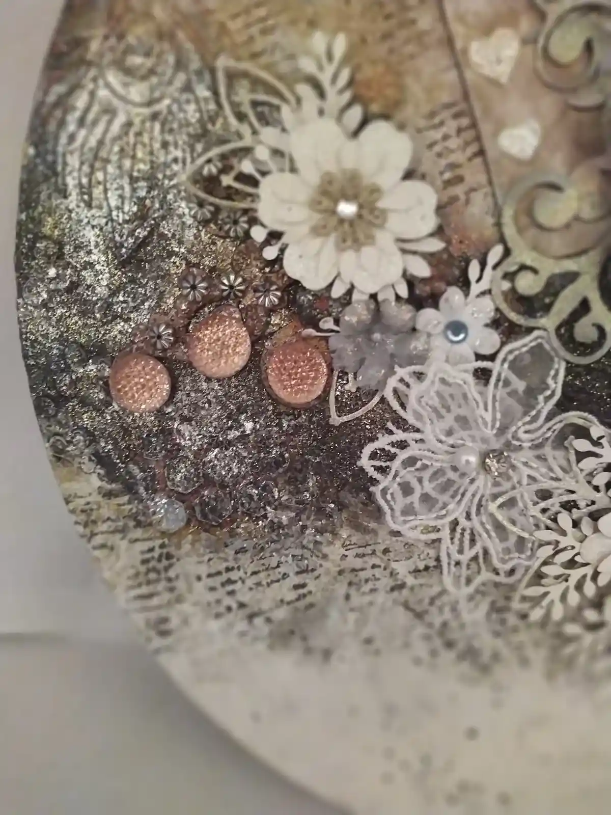 The Gentle Flutter, close up of mixed‑media artwork featuring a metallic butterfly, lace textures, and soft florals.