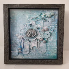Rhythms of Creation-1 A mixed media artwork featuring textured layers in soft baby blues, incorporating recycled materials like wood, paper, and plastic, creating a visually dynamic and harmonious composition that symbolizes transformation and renewal.
